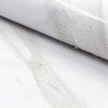 Close-up of white marble peel-and-stick wallpaper showing water droplets on a surface.