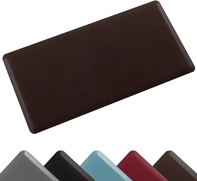 A dark brown anti-fatigue standing mat shown from above, with several colored mats in the foreground.