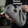 A hand holds a roll of gray microfiber cleaning cloths, demonstrating random packaging.