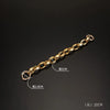 A gold-colored acrylic chain strap measuring 20cm in length and 2.8cm in thickness.