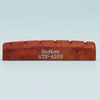 A wooden acoustic guitar bridge saddle with the name Guyker ATR-4359 engraved on it.