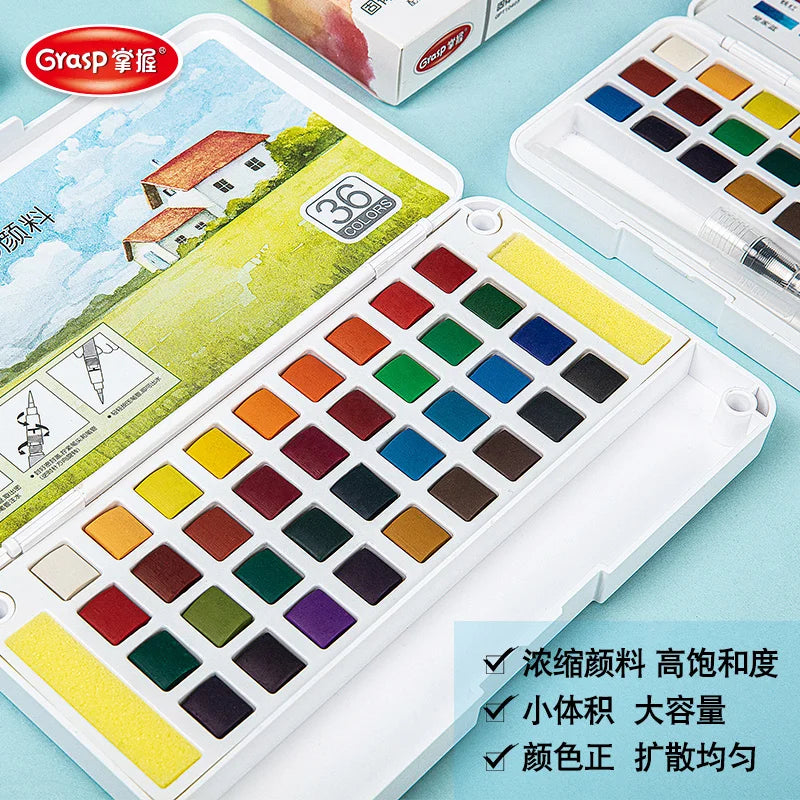 A white watercolor paint set featuring a palette of 36 colors and water brush pens is displayed on a light blue surface.
