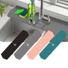 A set of silicone faucet mats in black, gray, pink, and teal are displayed on a kitchen sink with a faucet.
