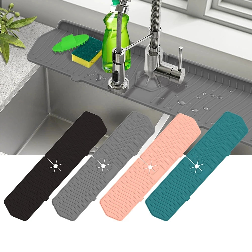 A set of silicone faucet mats in black, gray, pink, and teal are displayed on a kitchen sink with a faucet.