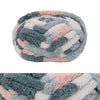 A ball of chunky chenille yarn in a mottled gray and pink color blend.