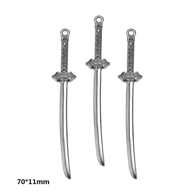 A set of three silver gun-shaped charms for DIY jewelry making with decorative details.