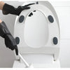 A hand wearing a black rubber cleaning glove is operating a white, circular cleaning device.