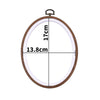 A wooden embroidery hoop with measurements marked, showing a circular frame for cross-stitch and needlework.