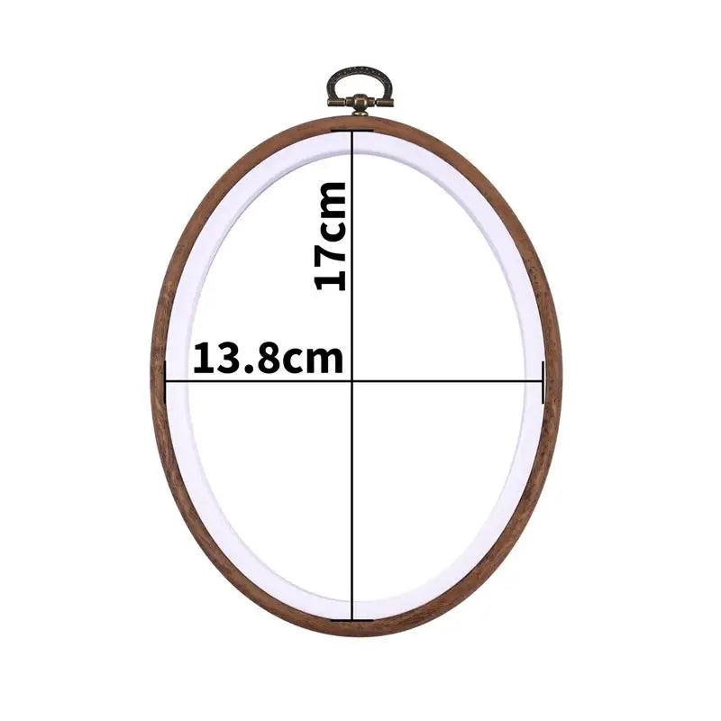 A wooden embroidery hoop with measurements marked, showing a circular frame for cross-stitch and needlework.