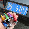 A hand holds a set of colorful rust-resistant license plate screws with various metal finishes.