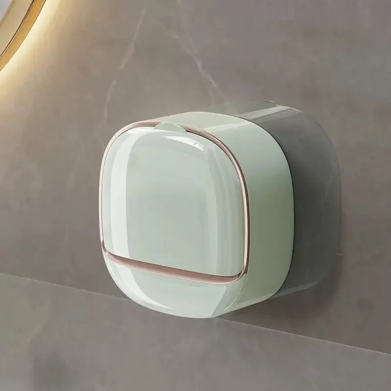 A modern, translucent white soap holder with a pink accent is mounted on a wall.