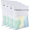 A stack of white reusable mesh laundry bags with a silver zipper visible.