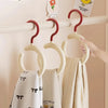 A white Nordic wall-mounted hat and scarf organizer hook displaying various light-colored scarves on a wooden rack.