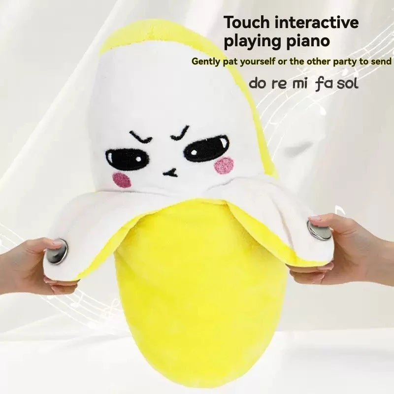 A yellow fruit-shaped plush toy with a face is being gently patted by a hand.