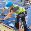 A construction worker wearing a blue hard hat and safety vest is working on a roof structure.