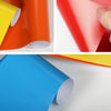 Close-up view of various colored tailgate insert decals for Ford Super Duty trucks, including orange, red, and blue.