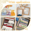 A collection of colorful yarn pom-poms and tassels displayed on a wooden weaving loom kit.