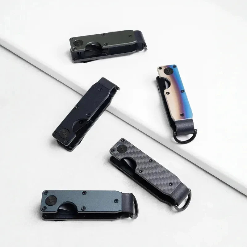 A collection of minimalist aluminum key organizers in black and blue tones displayed on a white surface.