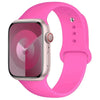 A pink silicone sport band is shown around an Apple Watch, highlighting the watch and strap.