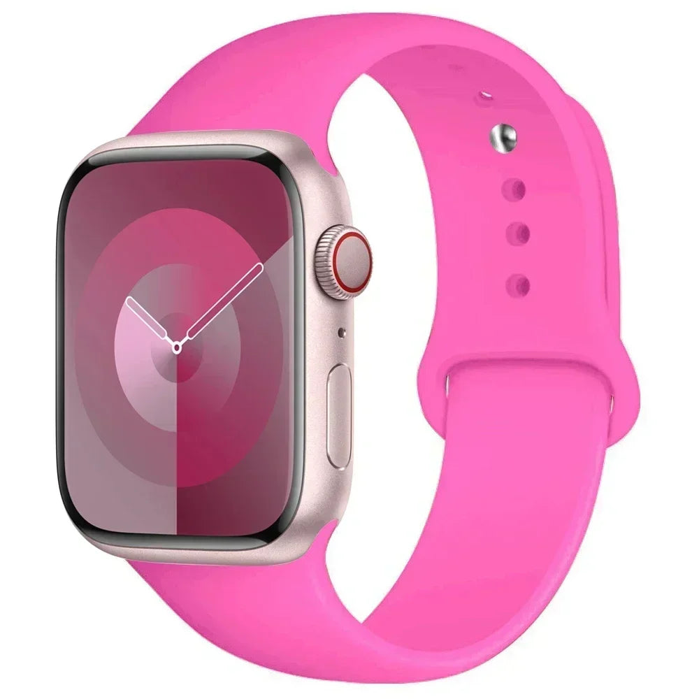 A pink silicone sport band is shown around an Apple Watch, highlighting the watch and strap.