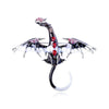 A detailed enamel dragon brooch featuring silver accents and red rhinestones.