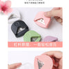 A set of pink and green paper corner rounder cutters for DIY crafts, showing the tools and a finished cut piece.