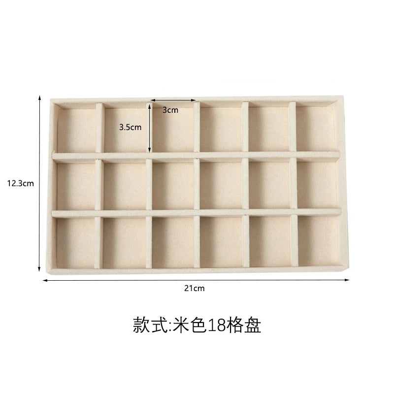 A light beige velvet jewelry organizer tray with 18 detachable compartments.