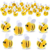 A collection of yellow wool felt bee pompoms used for crafts and party decorations.