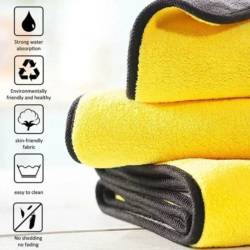 A stack of yellow and black microfiber cleaning towels with icons highlighting strong water absorption, eco-friendliness, ski