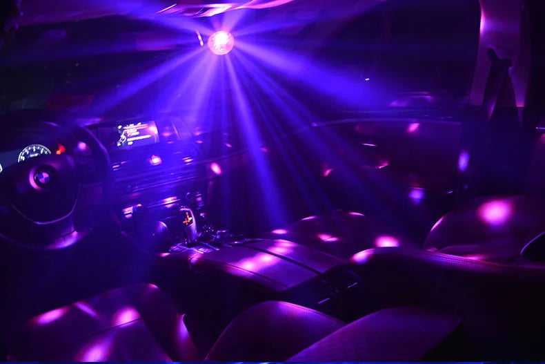 Interior view of a car with purple light beams shining from a disco ball party light