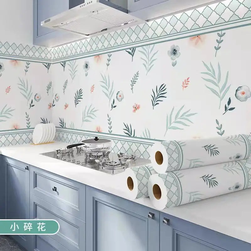 Light blue and green botanical patterned self-adhesive kitchen splashback sticker wallpaper on cabinetry.
