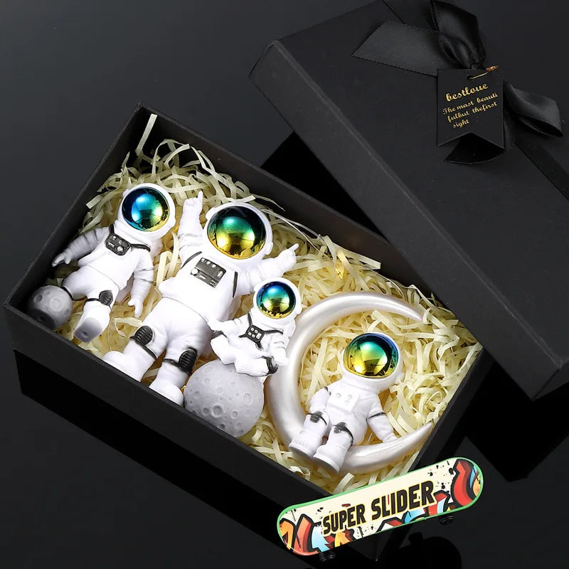 A black box contains a handcrafted astronaut figurine resin spaceman desk decor and a skateboard.