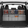 Interior view of a car showing a foldable trunk organizer with seat back storage and various items in the compartments.