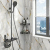 A shower fixture with a handheld sprayer and a wall-mounted soap dish is installed on a white marble tile wall.