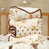 Stack of white cotton gauze baby swaddle blankets with bear print designs