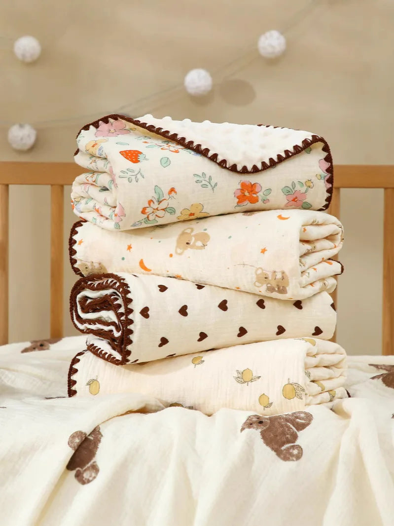Stack of white cotton gauze baby swaddle blankets with bear print designs