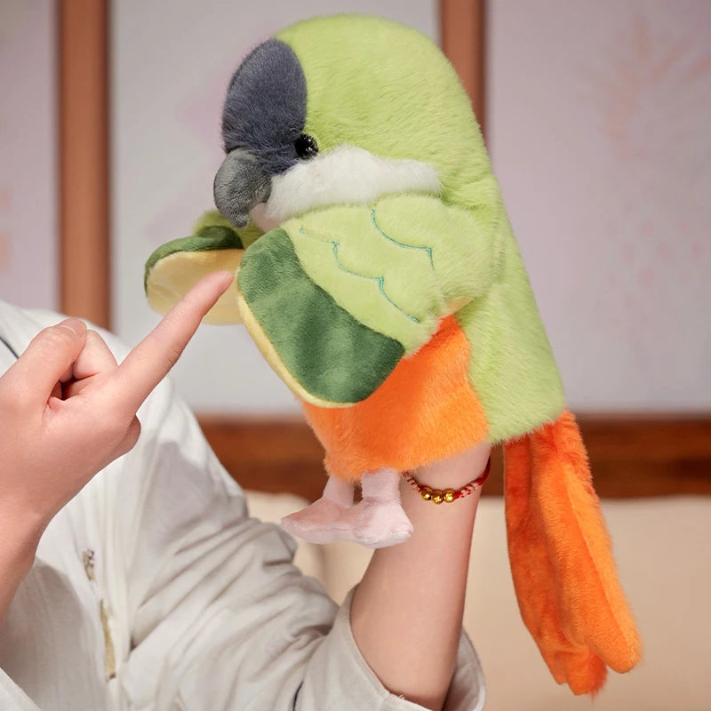 A hand puppet toy shaped like a green and gray parrot is being held by a person's hand.