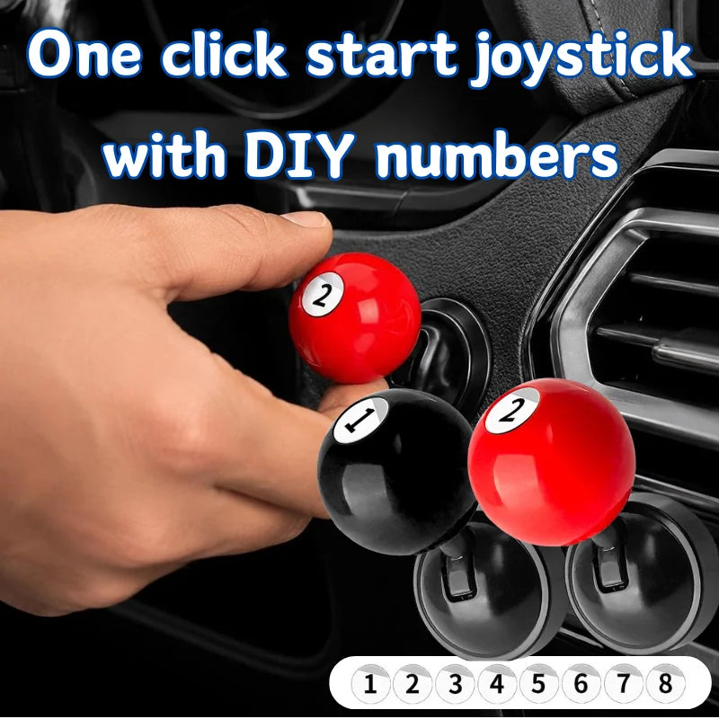 A hand is shown placing numbered billiard balls onto a metal push-to-start joystick cover.