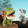 A green dinosaur figurine with yellow eyes stands next to a gray dinosaur figurine on a wooden surface.