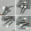 A collection of stainless steel multi-purpose scrapers and spatulas shown in various angles on a black mesh tray.