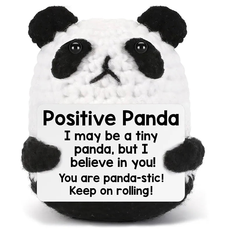 A white and black panda crochet doll with a positive message card that says I may be a tiny panda but I believe in you