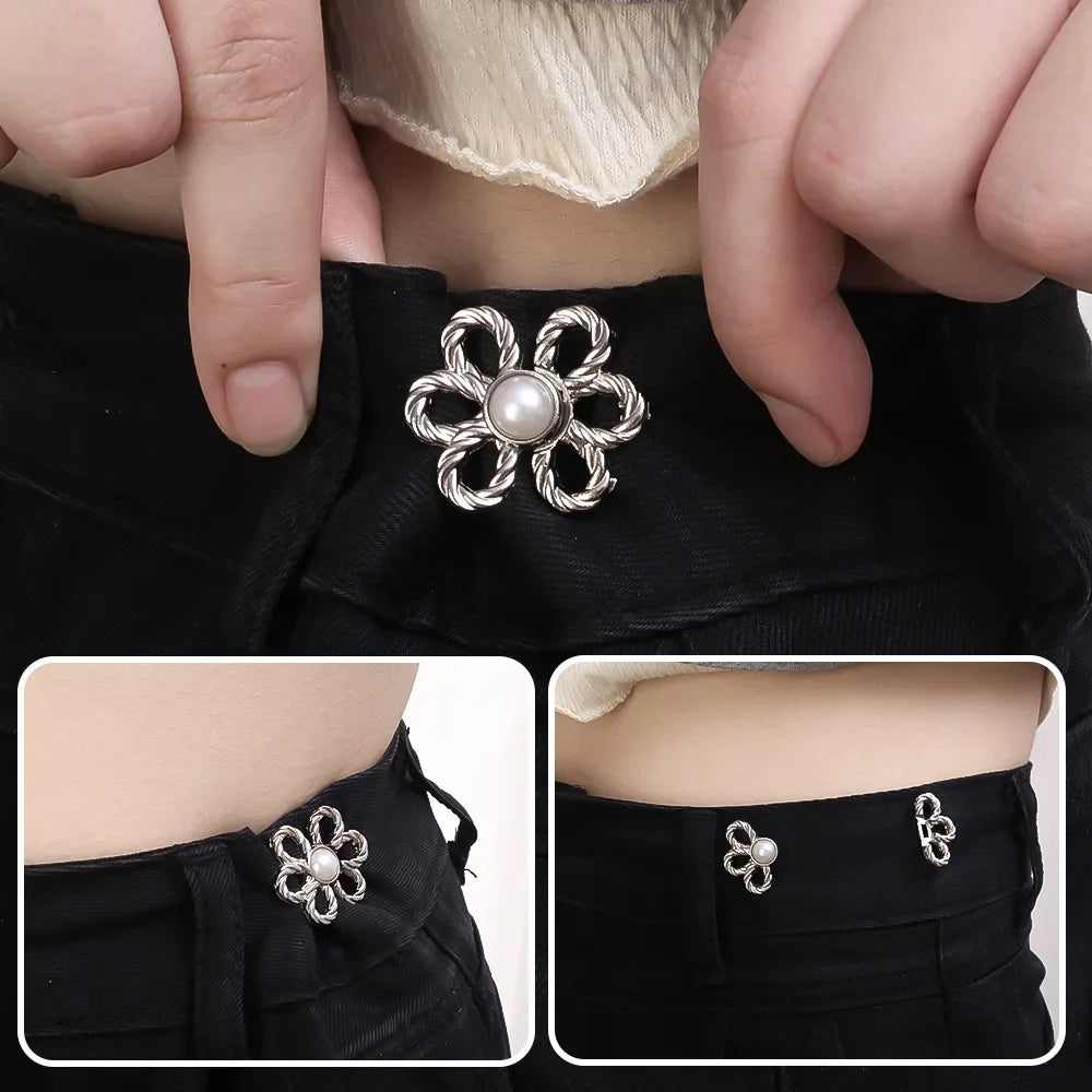 Close-up of an adjustable silver flower waist clip fastened onto a black garment.