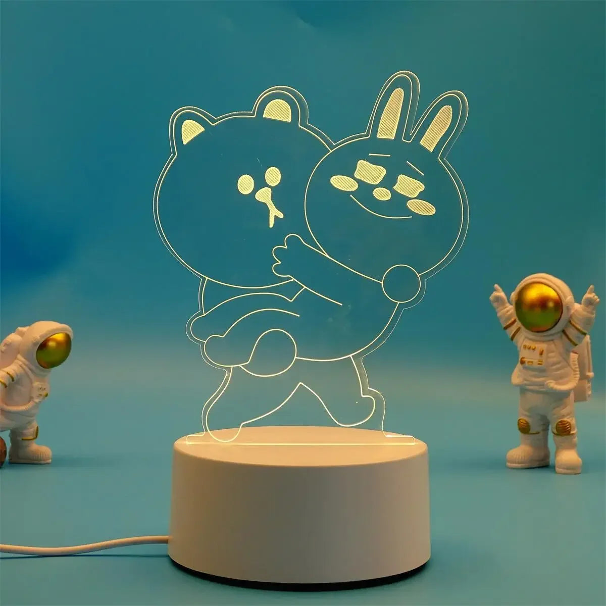 A glowing outline of two cute animal characters, a bear and a rabbit, displayed on a white base.