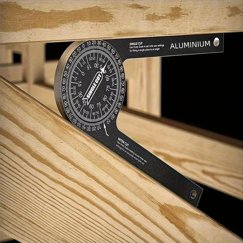 A black aluminum miter saw protractor with laser-engraved scales is shown on a wooden surface.