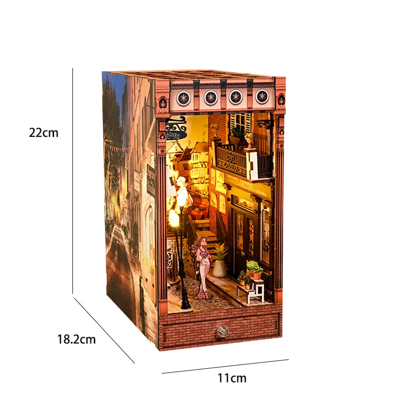 A miniature DIY book nook kit featuring a detailed room scene with architectural elements and lighting.