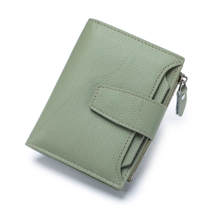 A light sage green genuine leather RFID blocking bi-fold wallet shown from above.