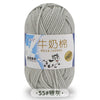 A ball of gray milk cotton blend yarn with a label in Chinese and English indicating stretch properties.