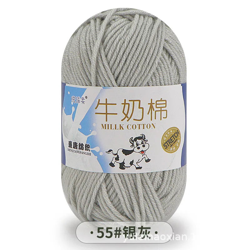A ball of gray milk cotton blend yarn with a label in Chinese and English indicating stretch properties.