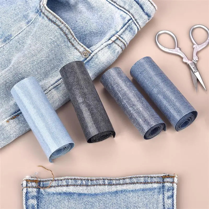 Rolls of denim fabric and a pair of scissors are shown on a light pink background for iron-on patches.
