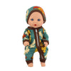 A baby doll wearing a green and brown floral jumpsuit outfit.